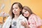 Portrait of adorable twin sisters posing in studio