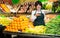 Portrait of adult female selling fruits and vegetables