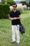 Portrait of adult golf player man standing on beautiful golf course