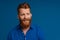 Portrait of adult handsome stylish redhead bearded smiling man