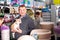 Portrait of adult man with dog in petshop, boy on background