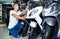 Portrait of adult man purchaser choosing motorbike