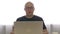 Portrait adult man working on notebook computer, smile and looking into camera