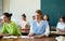 Portrait of an adult positive female student during class in university auditorium