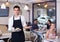 Portrait of adult waiter inviting to coffee