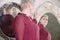 Portrait of an adult woman in a furniture store choosing herself a mirror. Several reflections in the mirrors