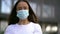 Portrait of adult woman with protective face mask outdoors, pandemic of coronavirus