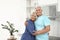 Portrait of affectionate senior couple in kitchen