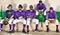 Portrait of african american baseball players sitting side by side in dugout