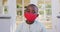 Portrait of african american boy wearing face mask outdoors on a bright sunny day