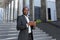 Portrait of an African American businessman, attorney wearing a suit and standing outside, posing, looking at the camera