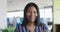 Portrait of african american businesswoman looking at camera and smiling at office, slow motion