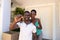 Portrait of african american couple moving house holding keys and smiling