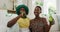 Portrait of african american couple in st patrick`s day hats holding beers smiling to camera. staying at home in isolation