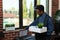 Portrait of african american employee being fired closing laptop with business data while holding tray