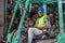 Portrait of African American factory man with smiling sit on forklift during work in workplace area of automotive or mechanic part