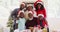 Portrait of african american family in santa hats smiling together at home