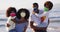 Portrait of african american family wearing face masks at the beach