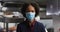 Portrait of african american female manager wearing face mask in restaurant kitchen