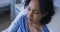 Portrait of african american female patient lying on hospital bed feeling pain