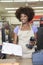 Portrait of an African American female store clerk standing at checkout counter