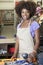 Portrait of an African American female store clerk standing at checkout counter