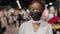 Portrait of african american girl woman shopper consumer female consultant salesperson wears black medical face mask