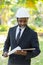 Portrait of african american industrial engineer manager with green natural background