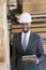 Portrait of African American male contractor using tablet PC with wooden planks in background