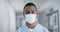 Portrait of african american male doctor wearing face mask, slow motion