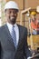 Portrait of African American male engineer smiling with female worker in background