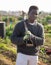 Portrait of a African American male gardener with a shovel in his hands