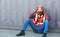 Portrait of an African American male technician or engineer. Sit near a shipping container and look tired and sleepy or unemployed