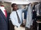 Portrait of African-american man buyer choosing business style jacket in the shop