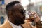 Portrait of a african american man drinking a soda on the terrace of a bar