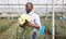 Portrait of african american man with fresh cut carnation flowers