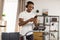 Portrait of African American man in t-shirt and headphones with phone on his hand on treadmill