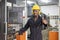 Portrait of African American mechanic engineer worker wearing safety equipment showing thumbs up beside the automatic lathe