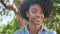Portrait african american teenager sitting sunny nature. Girl looking camera