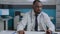 Portrait of african american therapist doctor analyzing sickness diagnostic document