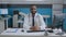 Portrait of african american therapist doctor sitting at desk working at medical expertise