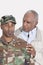 Portrait of an African American US Marine Corps soldier with father over gray background