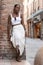 Portrait of African American woman dressed in white getting to know Europe, Ferrara. Italy