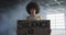 Portrait of african american woman holding protest placard in empty parking garage in empty parking