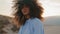 Portrait african american woman with lush curly hair at desert gloomy summer.