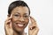 Portrait Of An African American Woman Trying On Eye Glasses