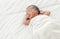 Portrait of african infant sleeping on bed