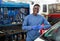 Portrait of african male mechanician posing in workshop