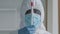 Portrait of african man doctor scientist medical worker wears protective clothing hood face mask and glasses looks at