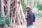 Portrait of African man traveler explorer with photo camera in forest